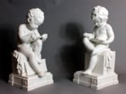 Dihl and Guérard biscuit figures depicting a boy reading and a girl writing.